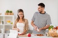 Happy couple cooking food at home kitchen Royalty Free Stock Photo