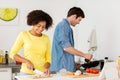 Happy couple cooking food at home kitchen Royalty Free Stock Photo