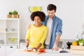 Happy couple cooking food at home kitchen Royalty Free Stock Photo