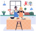 Happy couple cooking vegetable salad together. People preparing healthy food on kitchen table Royalty Free Stock Photo