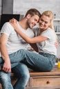 happy couple cuddling and sitting Royalty Free Stock Photo