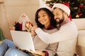 Happy couple cuddling while watching film on laptop Royalty Free Stock Photo