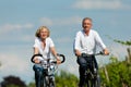 Happy couple cycling outdoors in summer Royalty Free Stock Photo