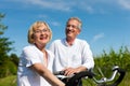 Happy couple cycling outdoors in summer Royalty Free Stock Photo