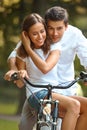 Happy couple cycling in the summer park Royalty Free Stock Photo