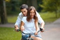 Happy couple cycling in the summer park Royalty Free Stock Photo