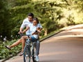 Happy couple cycling in the summer park Royalty Free Stock Photo
