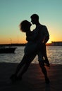 Happy couple dancing tango at sunset on the beach Royalty Free Stock Photo