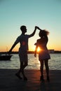 Happy couple dancing tango at sunset on the beach Royalty Free Stock Photo