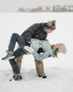 Happy couple dancing together in snow in winer