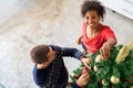 Happy couple decorating christmas tree