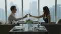 Happy couple dinner on high building with city skyline view