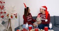 Happy couple with dog sitting on the sofa near Christmas tree Royalty Free Stock Photo