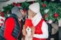 Happy couple and dog spending winter weekend outdoors, car travel. picnic in car trunk. Man kissing woman Royalty Free Stock Photo