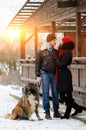 Happy couple with dogs in winter forest. Lovely moments outdoor