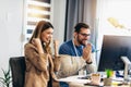 Couple doing business together working at home on the computer