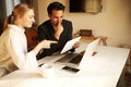 Happy couple doing business together working at small office on the laptop Royalty Free Stock Photo