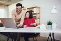 Couple doing business together working at small office on the laptop. They are using credit card for online shopping Royalty Free Stock Photo