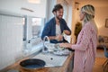 Happy couple doing the dishes together