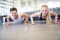 Happy Couple Doing Push Ups Together in Gym Royalty Free Stock Photo