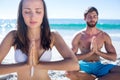 Happy couple doing yoga beside the water Royalty Free Stock Photo