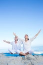 Happy couple doing yoga beside the water Royalty Free Stock Photo