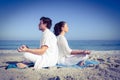 Happy couple doing yoga beside the water Royalty Free Stock Photo