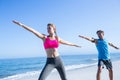 Happy couple doing yoga beside the water Royalty Free Stock Photo