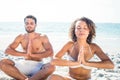 Happy couple doing yoga beside the water Royalty Free Stock Photo