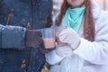 Happy couple drink hot chocolate outdoors, closeup. Woman with man holding cups of tea in hand`s gloves, loving family, Christmas