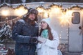 Happy couple drink hot chocolate outdoors, closeup. Woman with man holding cups of tea in hand`s gloves, loving family, Romantic Royalty Free Stock Photo