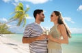 happy couple drinking champagne on tropical beach Royalty Free Stock Photo