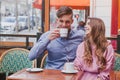 Happy couple drinking coffee in cafe