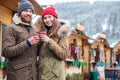 Happy couple drinking coffee on christmas market in mountain resort Royalty Free Stock Photo