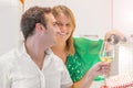 Happy couple is drinking a glass of white wine in the kitchen Royalty Free Stock Photo