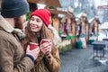 Happy couple drinking hot beverages on christmas market Royalty Free Stock Photo