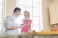 Happy couple drinking red wine in kitchen Royalty Free Stock Photo