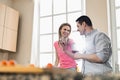 Happy couple drinking red wine in kitchen Royalty Free Stock Photo