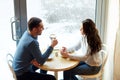 Happy couple drinking tea and coffee at cafe