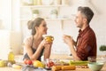 Happy couple drinking tea or coffee on kitchen Royalty Free Stock Photo