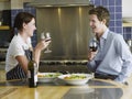 Happy Couple Drinking Wine In Kitchen Royalty Free Stock Photo