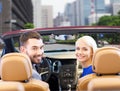 Happy couple driving in cabriolet car over city Royalty Free Stock Photo