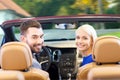 Happy couple driving in cabriolet car over city Royalty Free Stock Photo