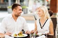 Happy couple eating dinner at restaurant terrace Royalty Free Stock Photo