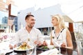 Happy couple eating dinner at restaurant terrace Royalty Free Stock Photo