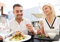 Happy couple eating dinner at restaurant terrace Royalty Free Stock Photo