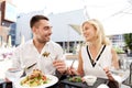 Happy couple eating dinner at restaurant terrace Royalty Free Stock Photo