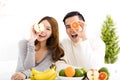 Happy couple eating fruit and healthy food