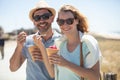 happy couple eating ice cream outdoors