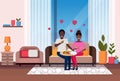 Happy couple eating pizza african american man woman sitting on couch modern apartment home living room interior male Royalty Free Stock Photo